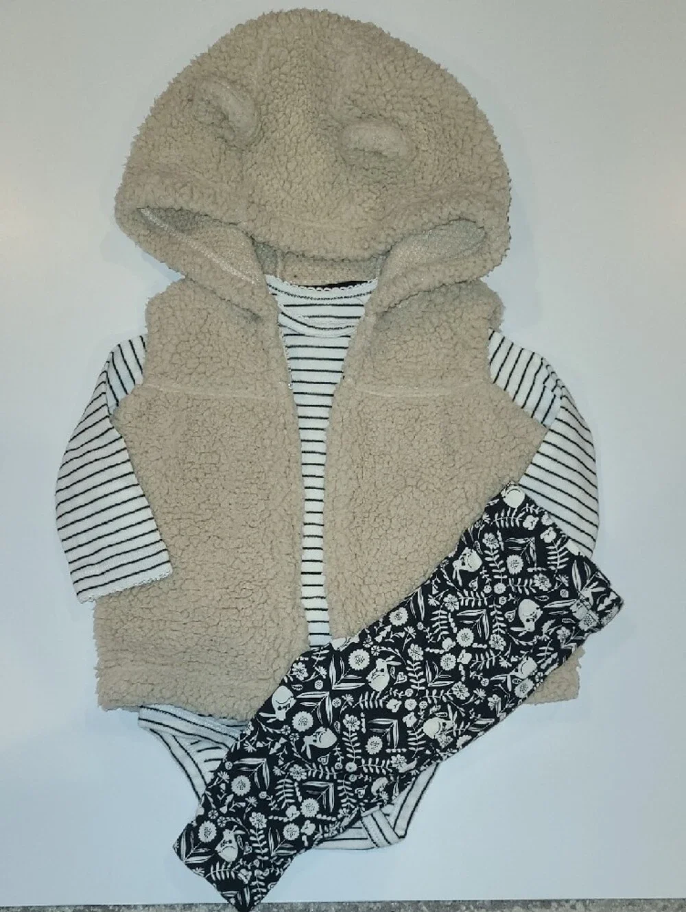Carters Beige Sherpa Hooded Baby Vest w/ Striped Top & Patterned Leggings.